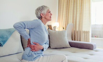 Cropped shot of a mature woman holding her lower back in discomfort due to pain in that area.