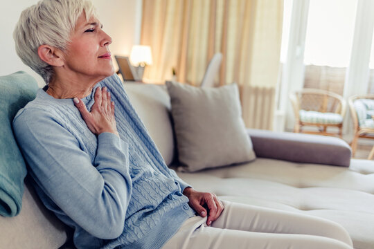 Female with chest pain. Senior woman suffering from heartburn or chest discomfort symptoms. Acid reflux or Gastroesophageal reflux disease (GERD) concept