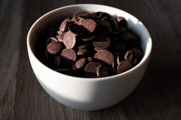 White bowl of dark organic chocolate