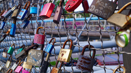 Love Lock Padlocks on Bridge with Lovers and friends initials on it in romantic gesture