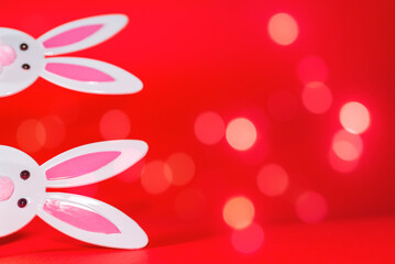 Two Toy Rabbit Bunny symbol of new year 2023 on red glowing bubbles background.Christmas or New Year concept.Copy space.
