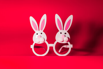 Obraz premium Two Toy Rabbit Bunny symbol of new year 2023 on red background.Christmas or New Year concept.