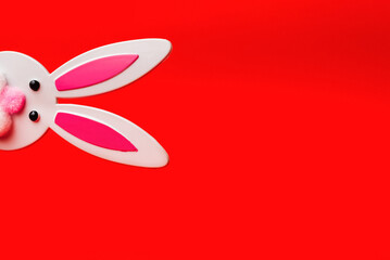Toy Rabbit Bunny symbol of new year 2023 on red background.Christmas or New Year concept.Copy space.
