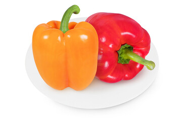 Red and yellow peppers on a white plate on an isolated white background.