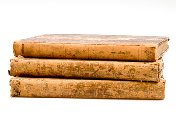 three old books stacked, spine view