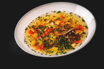 Bowl of meat and vegetable soup on a table