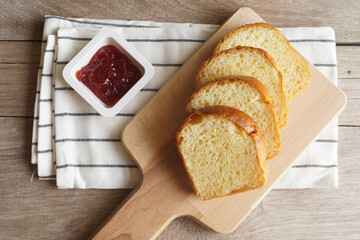 Homemade fresh bread with jam on wooden table - 539198552