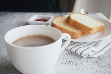 Hot coffee in a cup and bread for a delicious breakfast. - 539198587