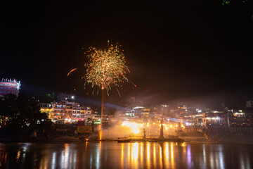 Fototapeta premium The Ganga River reflecting the festivities in the temples during the night.