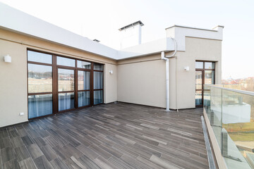 a large clean balcony in an apartment in a high-rise building