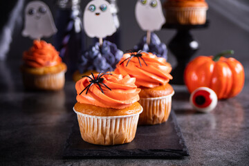Festive Halloween cupcakes decorated with sprinkles and candy spider