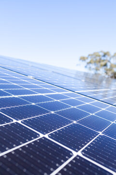 Solar panels on a house roof generating energy in sunlight