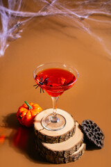 Halloween red cocktail in glass decorating spider. Party festive celebrate concept.