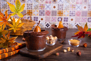 Sweet homemade autumn spicy biscuit mini pie in cup with whole pear