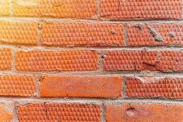 background of red textured relief brick. aged old stone wall or street texture blocks as backdrop closeup. pattern architecture construction design. flare
