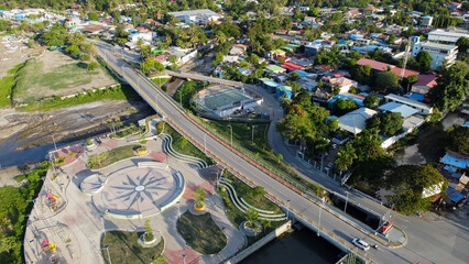 New inner city infrastructure developments of Habibie bridge and children's playground in capital city of Dili, Timor Leste, Southeast Asia, aerial drone view of landscape