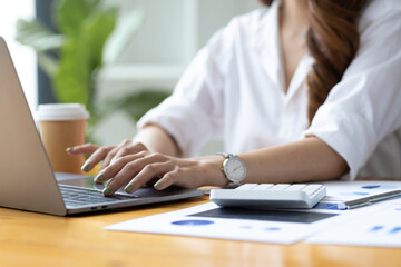 Female accountants working with laptops and business financial reports. Accounting Analysis and Money Planning