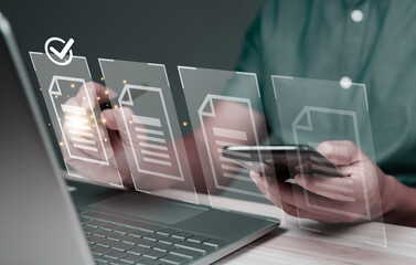 Hand using laptop computer with virtual screen and document for online approve paperless quality assurance and ERP management concept.