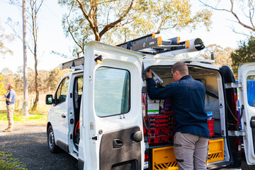 Male tradie and his work vehicle - electrician
