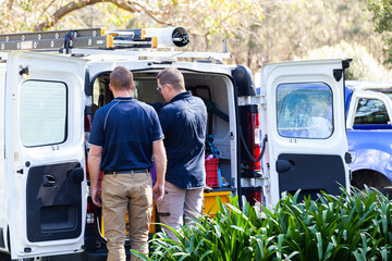 Two tradesmen and their vehicle