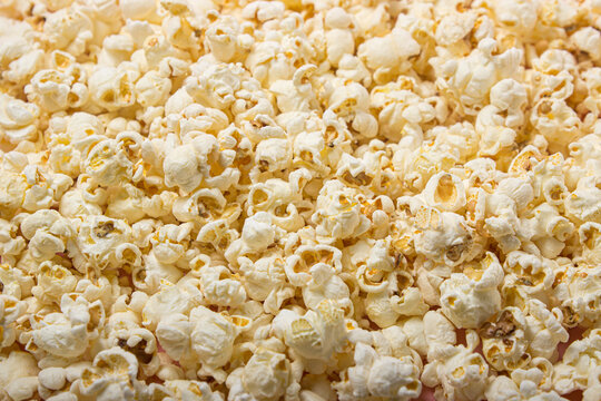 Popcorn in full screen as a background for the image. Delicious salty popcorn