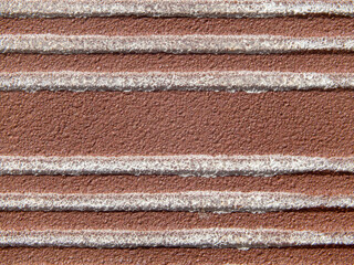 Background texture of a stone brown surface with white horizontal stripes
