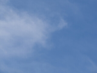 Summer blue sky and white cloud on a background. Beautiful transparent clouds in the sunlight in a calm season
