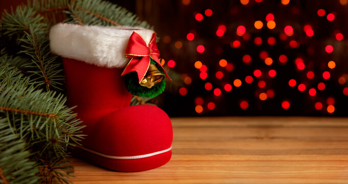 Christmas background with a toy boot and bokeh on the backdrop.