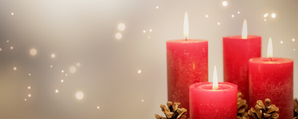 four red burning candles with shiny lights for christmas decoration, greeting card for december...