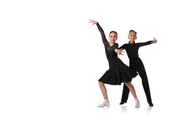 Dance couple. Two kids, school age girl and boy in black stage costumes dancing ballroom dance...
