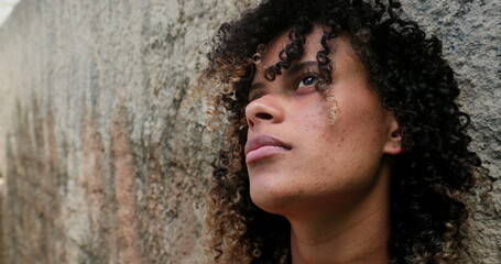 Contemplative latina young woman thinking. pensive south american person