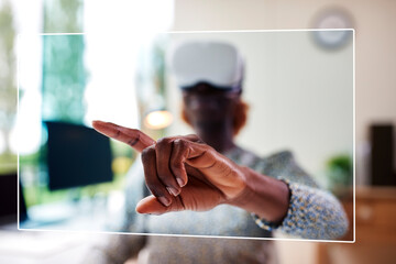 Woman Working From Home Office Sitting At Desk Wearing VR Headset Interacting With AR Technology