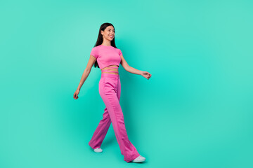 Fototapeta na wymiar Full length profile side photo of cheerful lady travel go walk wear trend set outfit isolated cyan color background