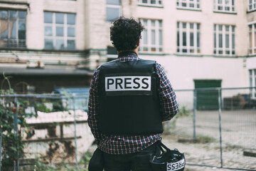 Photoreporter on his back with bulletproof vest
