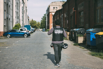 Photojournalist walking on a street 