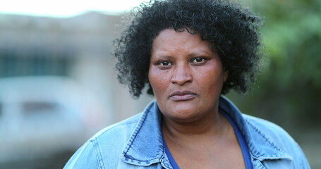 African woman close-up face, hispanic Brazilian ethnicity, serious emotion
