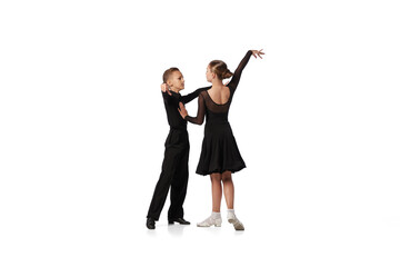 Dance couple. Two kids, school age girl and boy in black stage costumes dancing ballroom dance...