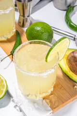 Classic refreshing alcoholic sweet and sour cocktail,  boozy Avocado and lime margarita shot drink with salt, Cinco de Mayo or mexican party ideas recipe