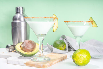 Boozy refreshing avocado alcoholic drink. Avocado martini cocktail, with lime, vodka, green hot chili peppers
