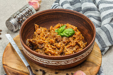 Stewed cabbage ready for eating. Homemade braised vegan food. Spices, herbs, cutlery