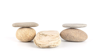 Fototapeta na wymiar Stacks of stones on a white background, front view. Zen like concepts. Stone podium for product presentation and branding. Spa stones treatment.