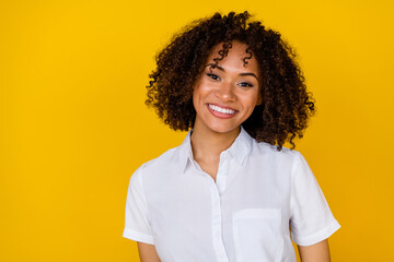 Portrait of gorgeous friendly satisfied girl beaming smile isolated on yellow color background