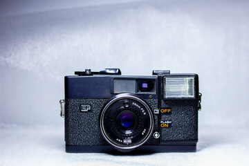Close up photo of retro old analog camera with lens 38mm illuminated with light painting. Vintage...