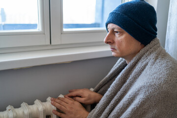 Man suffering cold at home and problem with house heating