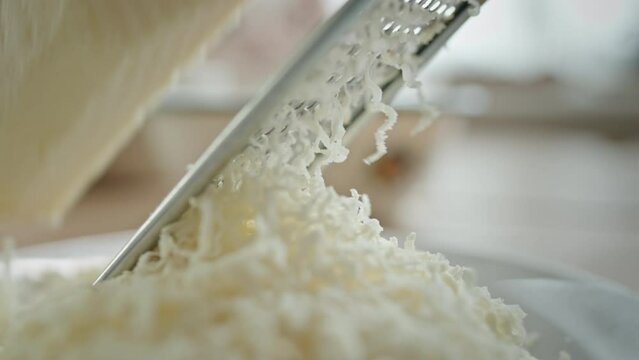 Anonymous Person Grating Cheese On Plate