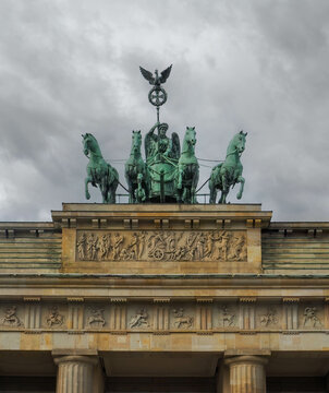 Brandenburg Gate Statue In Berlin Against A Cold Grey Sky.