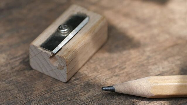 Wood grain pencil and sharpener on wooden background
