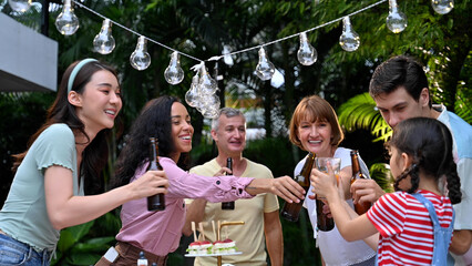 Young and elderly are eating and drinking at garden party, Outdoor party celebration with big family concept