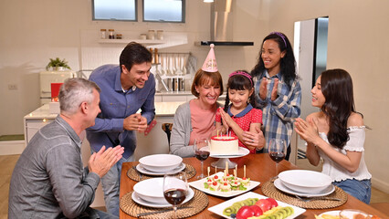 .Big family celebrating grandmother birthday at the dining table in the house