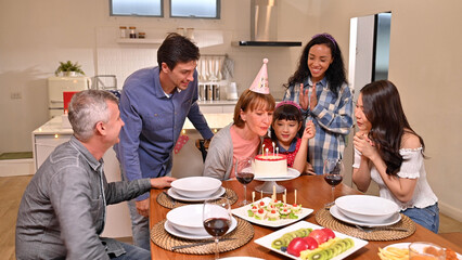 .Big family celebrating grandmother birthday at the dining table in the house